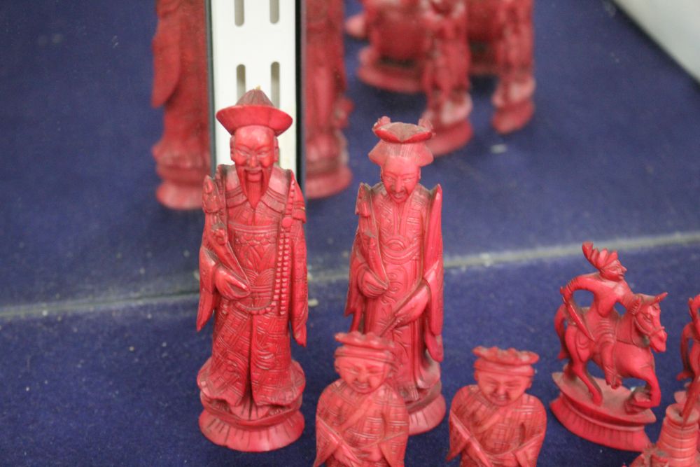 An early 20th century Chinese carved and red stained ivory chess set, carved as opposing Chinese armies, king 12cm